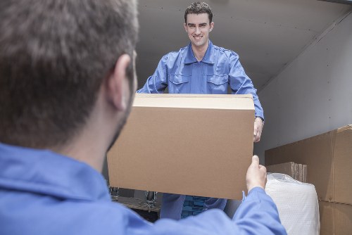 Man with a van loading household items in Queens Park
