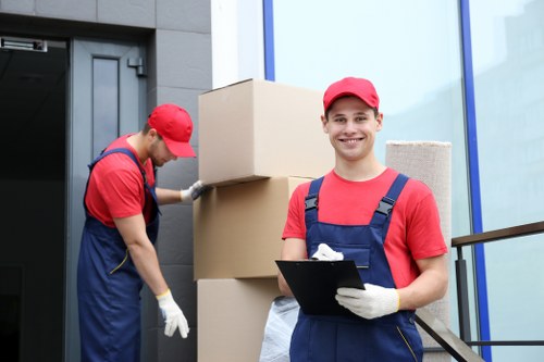Removal team preparing furniture for transport in Queens Park
