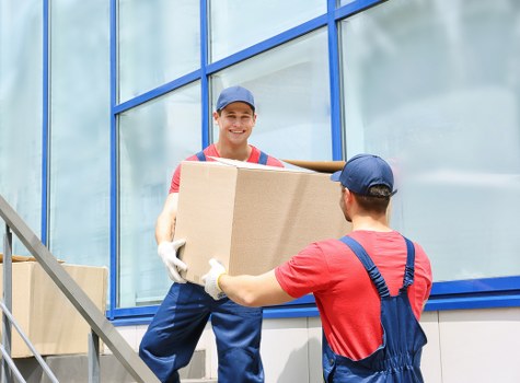 Moving truck and packing boxes for a Queens Park home relocation