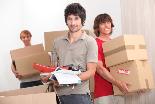 Careful loading of household items into a truck for Queens Park residents