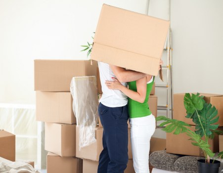 Packed moving boxes and furniture ready for house removals in Queens Park