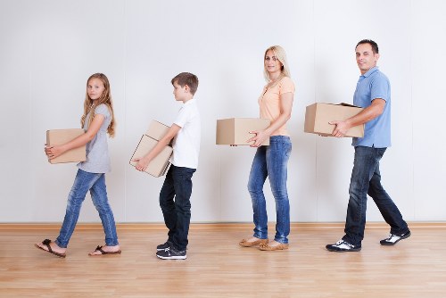 Local movers loading office items for a commercial move near Queens Park