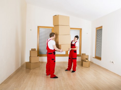 Packed boxes and furniture prepared for a house move in Queens Park