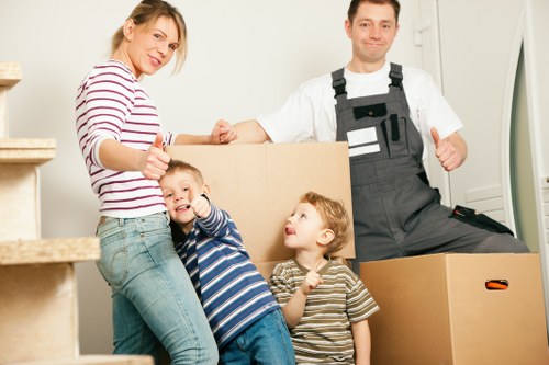 Boxes and furniture being loaded into a moving truck for a Queens Park relocation